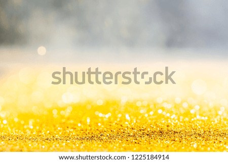 Gold glitter macro close-up texture with shallow depth of field and bokeh background, luxury value concept for christmas or birthday greetings and presents