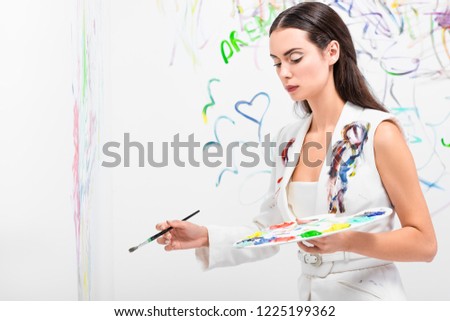close up of beautiful woman in total white posing with drawing equipment
