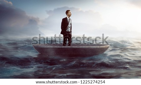 Businessman in a small boat swimming on the sea Royalty-Free Stock Photo #1225274254