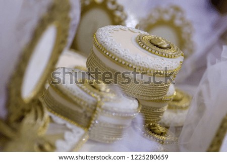 Elegant gifts in the form of boxes of fabric for guests at a wedding or other celebration, decorated with lace.