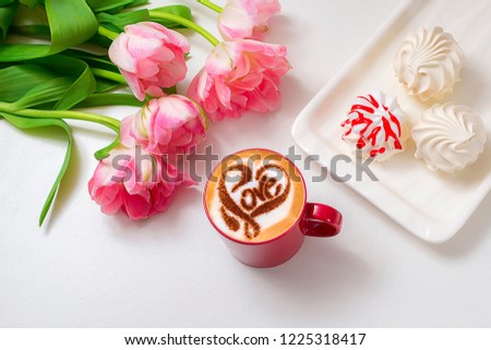 a cup of cappuccino coffee with a heart pattern and the words love on milk crema