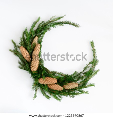 Christmas composition. Christmas wreath made of fir branches, balls, pine cones on white background. Flat lay, top view, copy space, square
