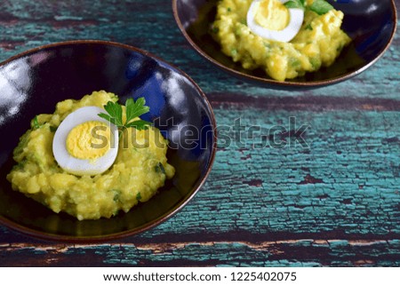 Pea mashed potato with hard boiled egg garnish with parsley 