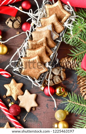 Christmas card with  cookies in the shape of stars decor gold, with candy,  tree and pine cones, and  balls yellow and red, Christmas 2019, new year is 2019, selective focus