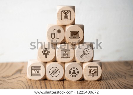 SEO strategy with components for successful marketing as icons on cubes on wooden background