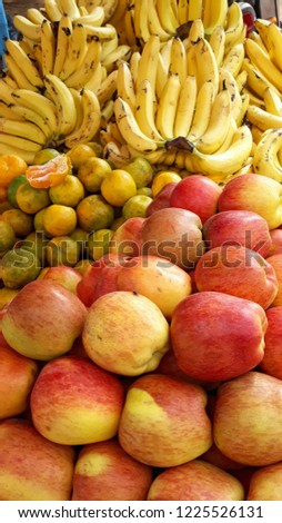 A picture of frutis which include apple banana and oranges