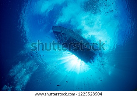 boat chain anchor from underwater with sun rays