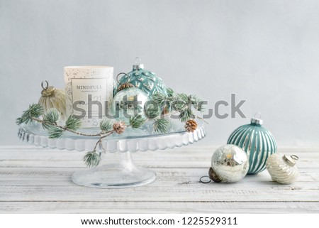Tray with christmas decorations and candle on white wooden background