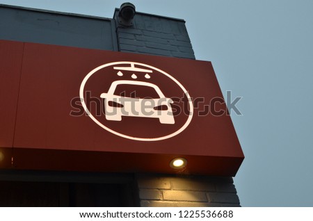 red sign with car wash image