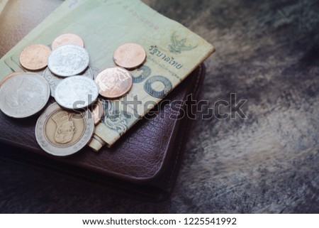 Money and leather wallet on wooden desk and copy space used for add messages.  