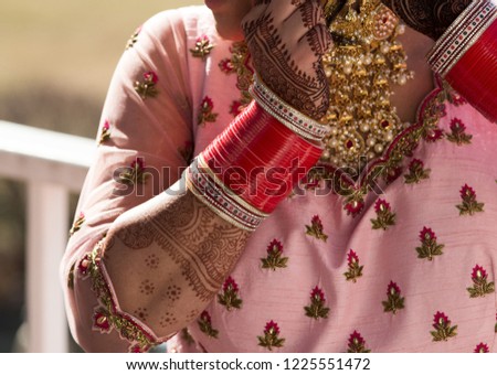 Indian pakistani bride showing her mehndi and bengals