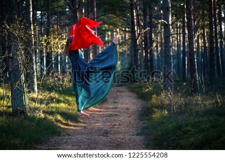 Beautiful, young woman levitating in woods. Flying in the dream. Lack of gravity. Concept of magic, wonderland and fairy tale in forest.  Royalty-Free Stock Photo #1225554208