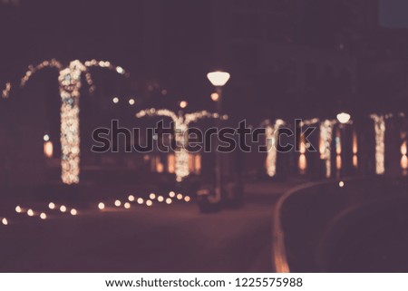 Blurred abstract urban background, bokeh of city lights, vintage or retro color tone.