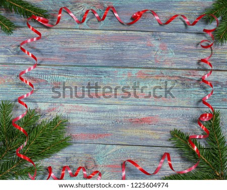Christmas and happy New year. On a dark wooden background juicy spruce branches, Christmas decorations, cones. Rustic style.