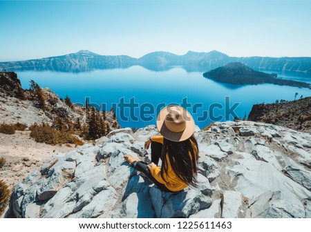 Girl sitting near Crater Lake overlook