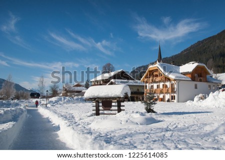 Woman walking in rural winter landscape, Weissensee, Carinthia, Austria
