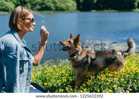 Image of woman with dog near pond