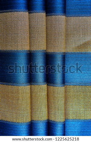 Golden fabric with blue stripes
