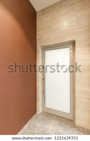 closed glass door in the office corridor