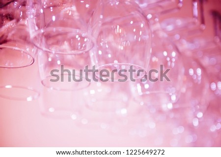 Stylish light pink background. Blurred glasses with bokeh