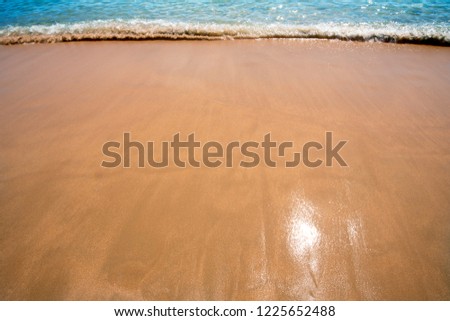 yellow sand beach with waves blue,background nature ocean
