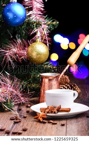 Coffee cup, jezve, under the Christmas tree on a wooden table