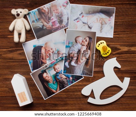 Mothers Day concept. Baby pictures, accessories and wooden toys on rustic wooden background. Top view, flat lay.
