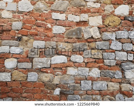 Old stone wall stones and bricks. History, art and tradition. Wall texture background natural col