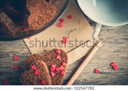 Card with Message Love You on the Letter and Chocolate Cookies Shape of Heart at Valentine's Day Royalty-Free Stock Photo #122567782