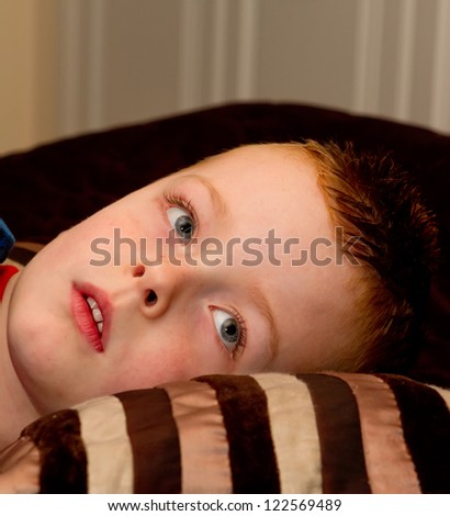 little boy relaxing on a pillow at bedtime