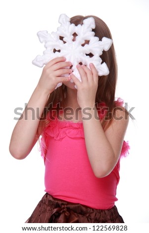 Pretty young girl posing on camera with lovely christmas decoration on Beauty and Fashion theme/Funny kid with huge white snowflake