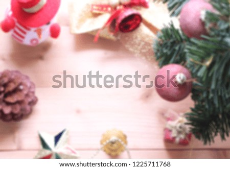 blurred christmas tree background with decorations on wooden board