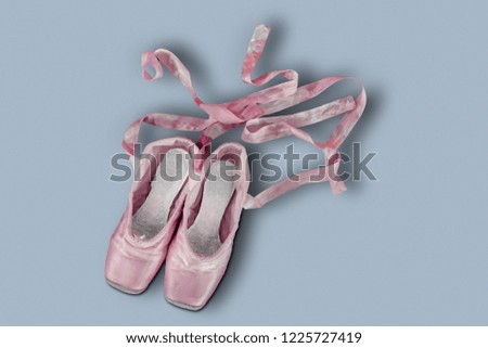 Top view of colored pink ballet shoes with gray background