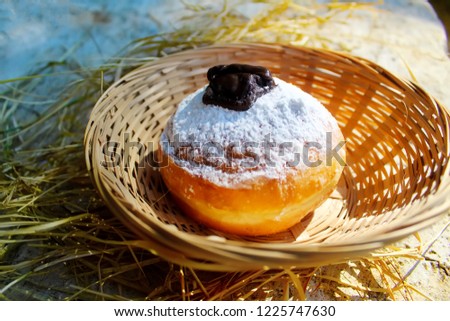 Hanukkah Sufganiyot (Sufganiyah). Hanukkah (Chanukah, Hanuka) - Jewish Holiday. Sufganiyah (Sufganiyot) - Festive Donut or Doughnut. Image of Jewish Holiday Hanukkah. Symbol Hanukkah, Food