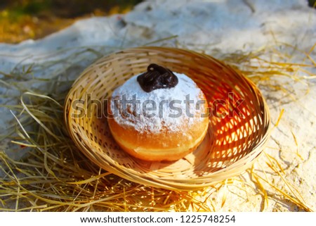 Hanukkah Sufganiyot or Sufganiyah. Hanukkah (Chanukah, Hanuka) - Jewish Holiday. Sufganiyah (Sufganiyot) - Festive Donut or Doughnut. Image of Jewish Holiday Hanukkah. Symbol Hanukkah, Food