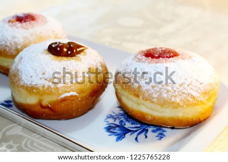 Hanukkah Sufganiyot (Sufganiyah). Hanukkah (Chanukah, Hanuka) - Jewish Holiday. Sufganiyah (Sufganiyot) - Festive Doughnut or Donut. Image of Jewish Holiday Hanukkah. Symbol Hanukkah, Food