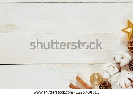 Beautiful white wooden Christmas background. Winter cones, cotton, top view