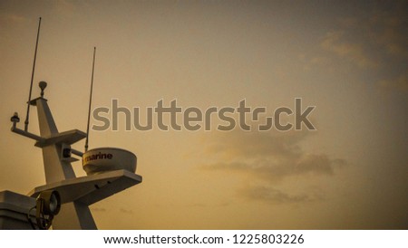 a boat with radar satellite ship navigation radar on sunrise or sunset view yellow sky in karimun jawa indonesia Royalty-Free Stock Photo #1225803226
