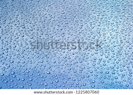 Water drops on a blue surface. Background, texture