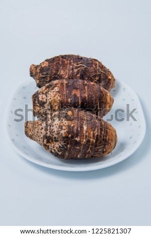 taro root in plate on white background