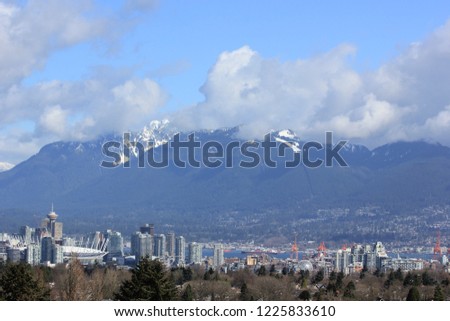 Vancouver skyline - snow capped mountain range from Queen Elizabeth Park, on a Spring morning, Vancouver, Canada 