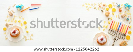 Banner of jewish holiday Hanukkah background with traditional spinnig top, menorah (traditional candelabra) and burning candles