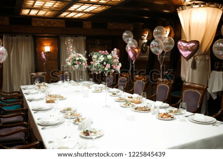 Big table served with food for family and friends for Happy Birthday party in restaurant.
