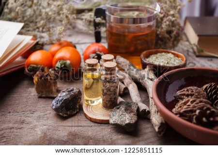 Authentic interior details, glass of herbal rea, dry herbal plants, homeopathic treatment on rustic wooden background, alternative medicine, healthy closeup