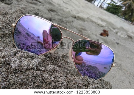 Beautiful Eyeglasses at the beach resort with reflection of people who took the picture