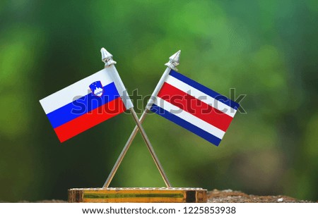 Costa Rica and Slovenia small flag with blur green background