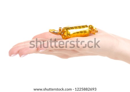 Christmas candy gold in hand on a white background. Isolation