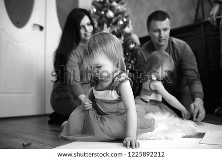 A young family with twins girls in the New Year's holiday