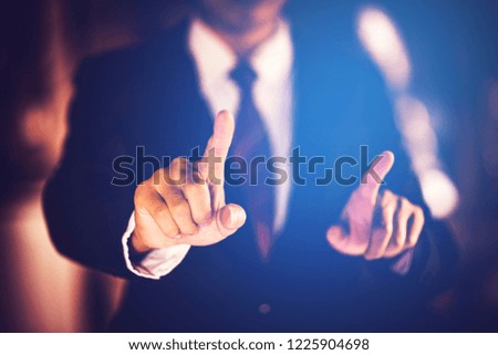 Businessman hand pointing on backdrop of the sunlight.