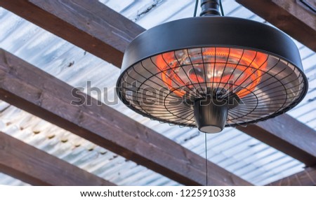 Radiant heater on the ceiling of a terrace roofing Royalty-Free Stock Photo #1225910338